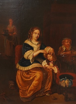 After Casper Netschel (Dutch, 1639-1684), 'Maternal Care', indistinctly signed lower right, chalk marks verso, oil on panel, 31 x 24cm, gilt frame